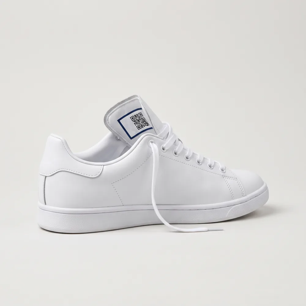 White sneaker with a digital product passport QR label inside the tongue